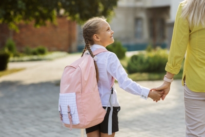 Side view girl holding hands with mother