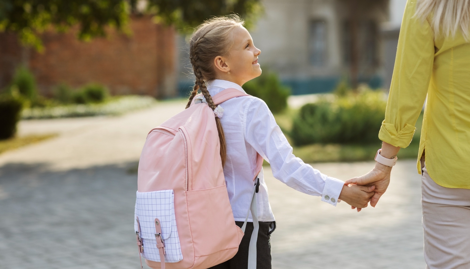 Side view girl holding hands with mother